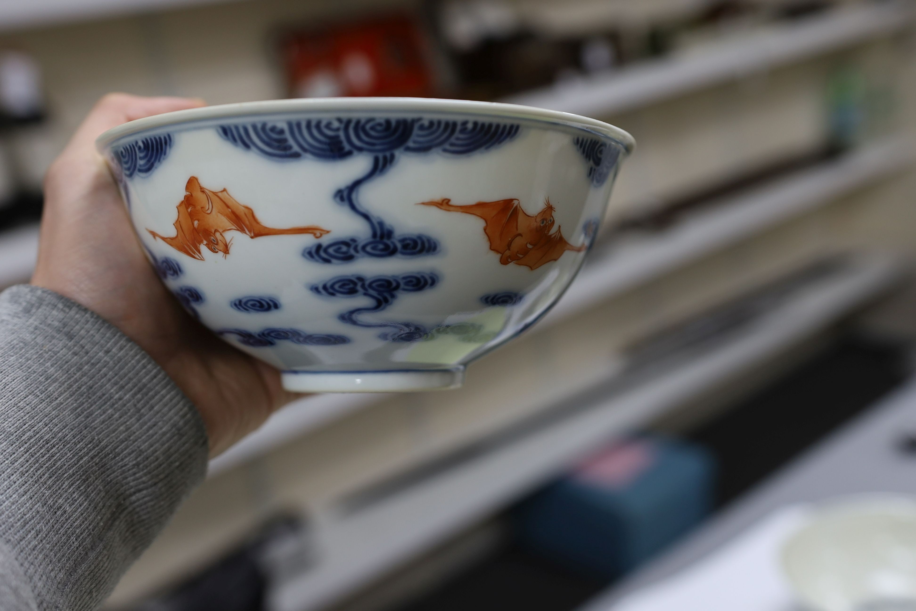 A pair of Chinese iron red and underglaze blue ‘five bat’ bowls, Guangxu mark and probably of the period (1875-1908), 16.5cm diameter